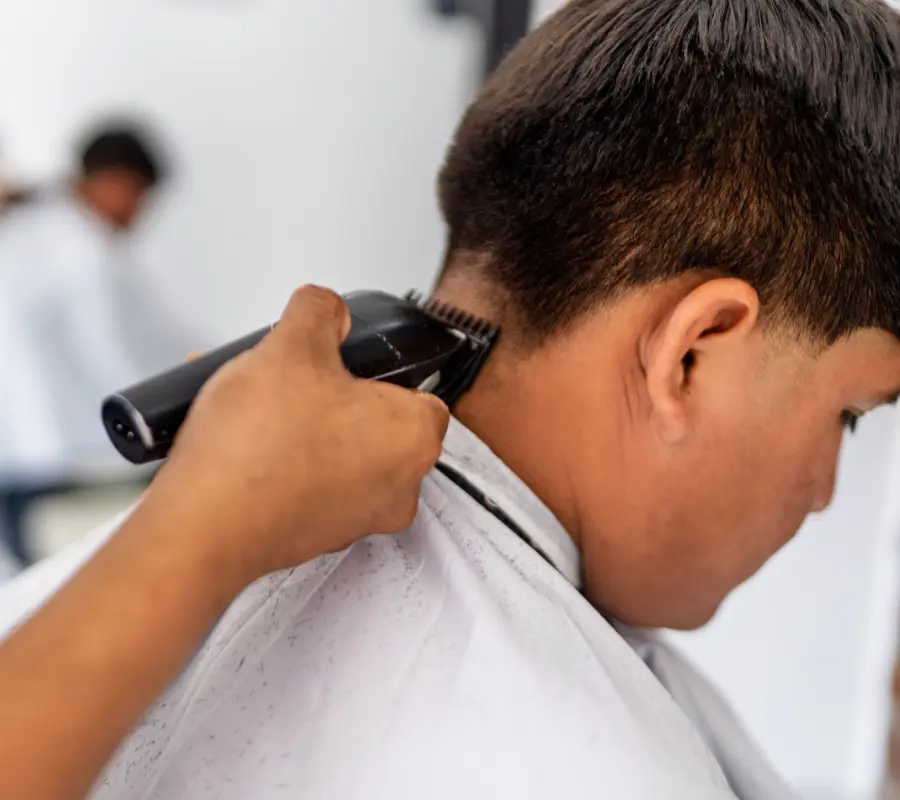 Master barber performing a precision kids fade haircut in the Sioux Empire
